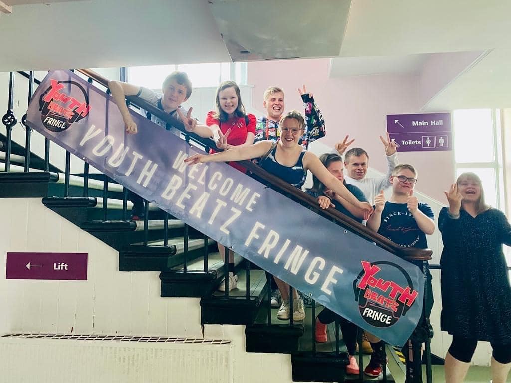 young people with Youth Beatz Fringe banner on a stairwell